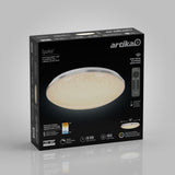 A box for the Artika Sparkle LED flush mount light, showing the light fixture, smart remote control, product features, and specifications on a gray background.