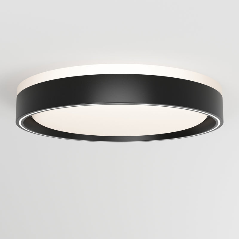 The Artika Callisto 15 in. LED flush mount light features a modern circular design with a black outer rim and white illuminated center, seamlessly mounted on a plain white ceiling.