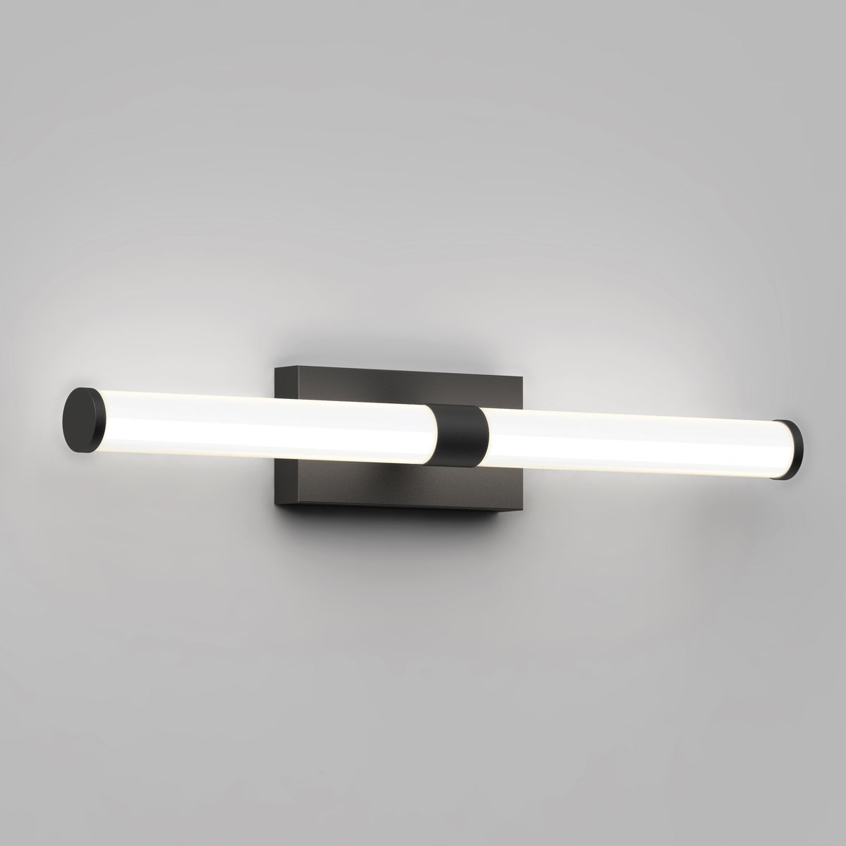 The Artika Vitoro modern LED bathroom vanity light features a horizontal cylindrical tube on a rectangular black base, emitting soft white light—ideal for contemporary home lighting.