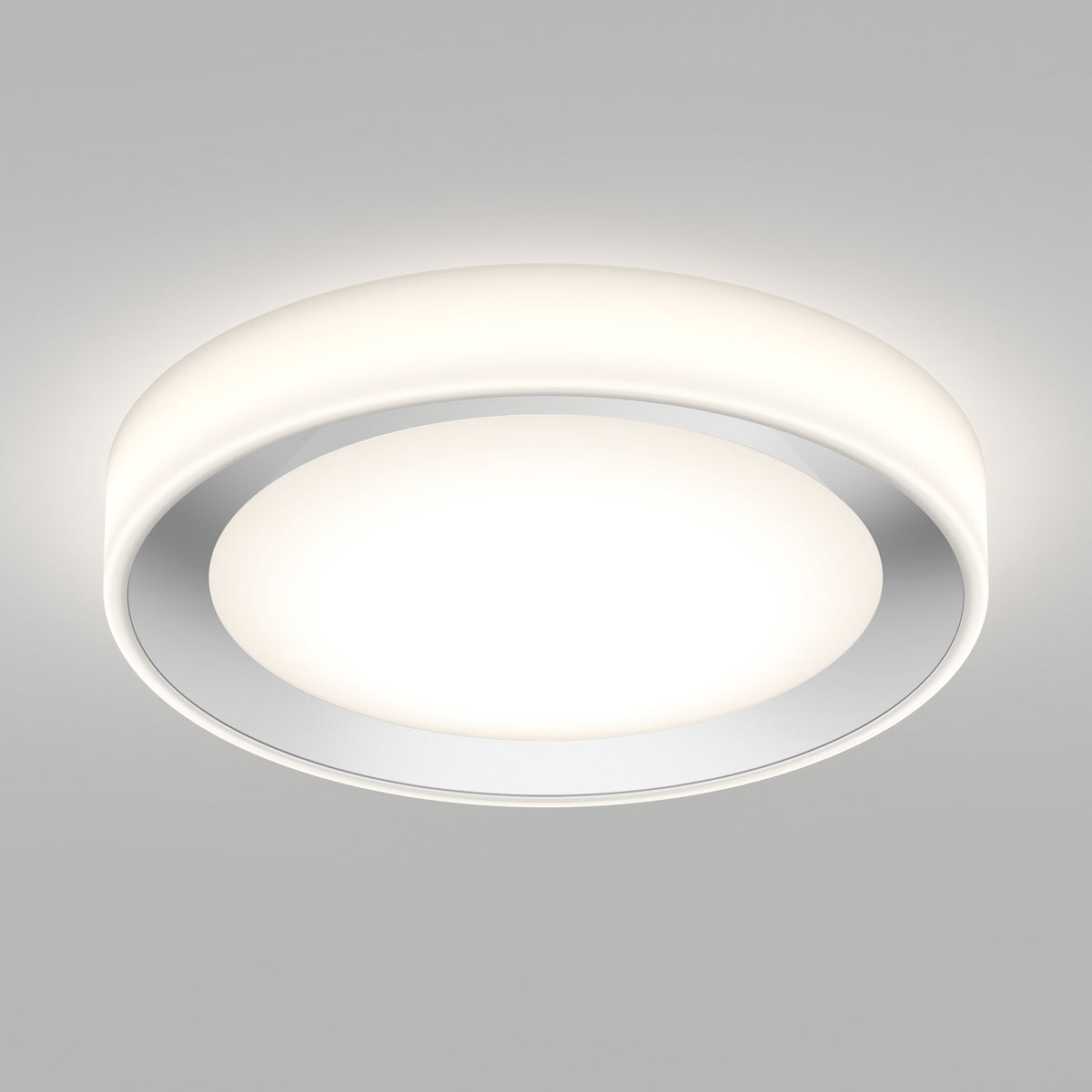 A modern, circular ceiling light fixture with a white rim and a glowing central disk, mounted on a plain light gray ceiling. The light emits a soft, even illumination.