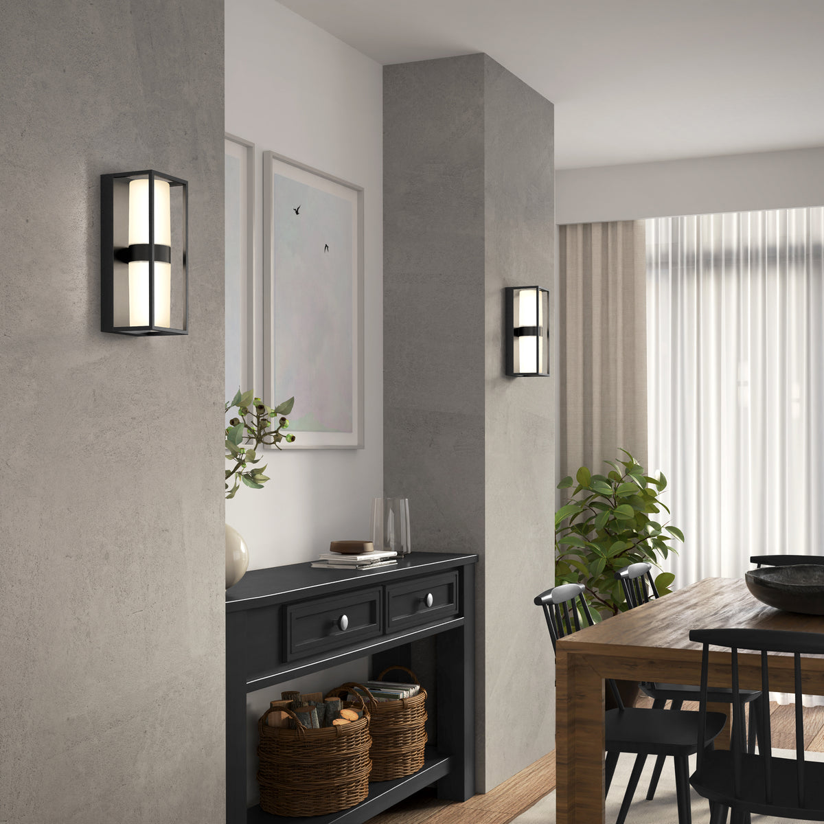 Modern dining area featuring a wooden table, black chairs, and a black sideboard against a gray wall. Two Artika Sherman modern LED indoor-outdoor wall lights (5 CCT) are mounted on the wall, with framed art, plants, and wicker baskets enhancing the decor.