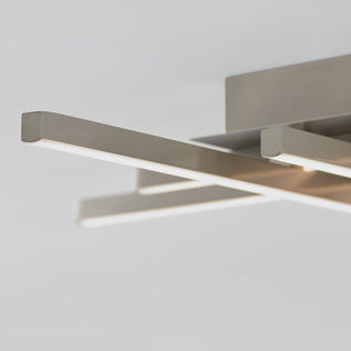 Close-up of the Artika Grid LED flush mount, featuring sleek, overlapping metallic bars and integrated LED strips, set against a plain white background.