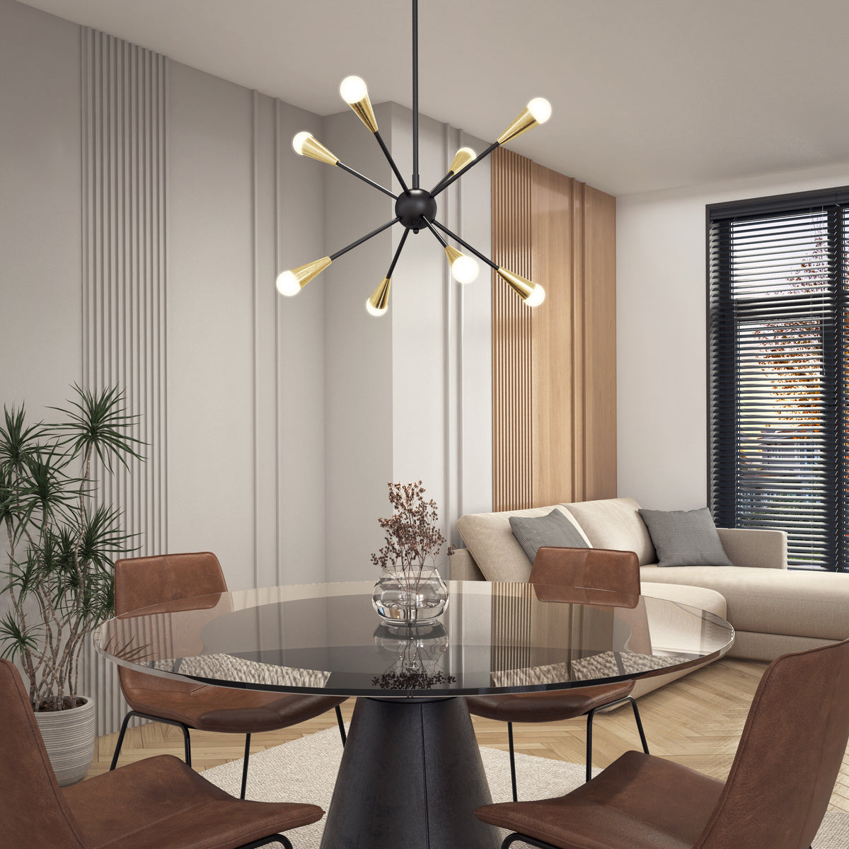Modern dining area with a round glass table, four brown chairs, a black and gold sputnik chandelier, a beige sofa, potted plant, and large window with black blinds letting in natural light.