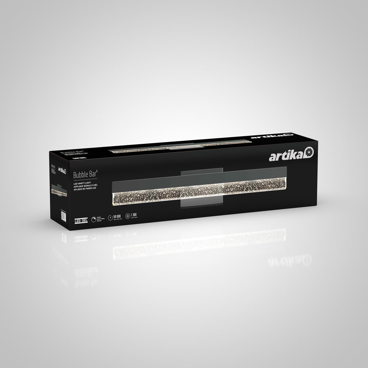 A rectangular black box with a transparent window displays an Artika Bubble Bar LED vanity light. The packaging features product information and branding on a gray gradient background.