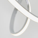 A close-up of two intersecting, white, illuminated rings with a minimalistic design against a light gray background. The rings create a modern and abstract geometric pattern.