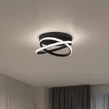 Modern ceiling light fixture with two intertwined, glowing LED rings mounted on a circular black base, illuminating a minimalist room with white walls, dark curtains, and a large window.