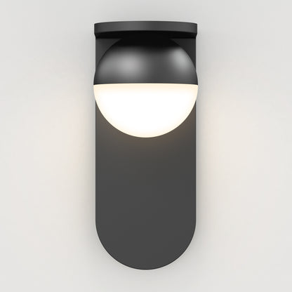 The Artika Bloom indoor-outdoor LED wall light 3 CCT features a modern black design with a rounded base and half-sphere white diffuser, casting a soft, diffused glow on any plain white wall.