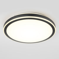 The Artika Altitude 15 in. LED modern flush mount light features a circular design with a black rim and white illuminated center, shown installed on a light gray ceiling. This 5 CCT fixture offers versatile, stylish lighting.