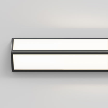 The Artika Preston LED modern bathroom vanity light features a rectangular black frame with white illuminated panels, shown mounted on a plain light grey wall.