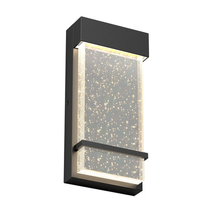The Skyler indoor-outdoor LED wall light by Artika features a modern rectangular matte black frame and a clear bubble-embedded panel, glowing with soft white LED illumination.