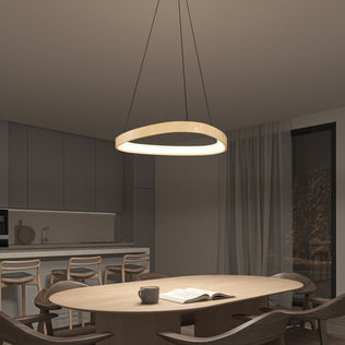 A modern dining room features a round wooden table, six chairs, an open book, a mug, and the Artika Bjorn modern LED pendant light 5 CCT hanging above. Gray cabinets, bar stools, and a large window with sheer curtains complete the space.