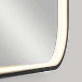 Close-up of the corner of a rectangular mirror with rounded edges and built-in LED lighting along the frame, emitting a soft white glow against a neutral background.