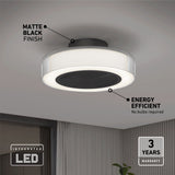 A modern ceiling light with a matte black finish and integrated LED, mounted on a white ceiling. Text highlights its energy efficiency and 3-year warranty. Room decor is minimal with a hint of a plant visible.