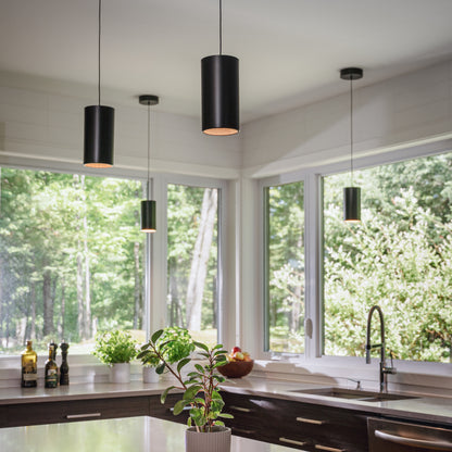 Modern kitchen with Artika Alton mini LED pendant lights (5 CCT), large windows, and a view of greenery outside.