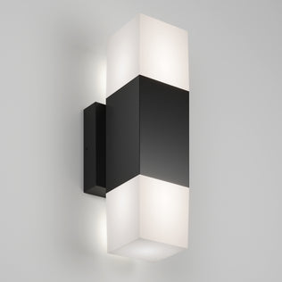 The Artika Lennox indoor-outdoor LED wall light 3 CCT features a rectangular black center with frosted white diffusers on top and bottom, mounted on a light gray wall.