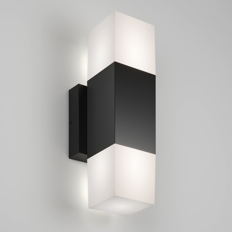 The Artika Lennox indoor-outdoor LED wall light 3 CCT features a rectangular black center with frosted white diffusers on top and bottom, mounted on a light gray wall.