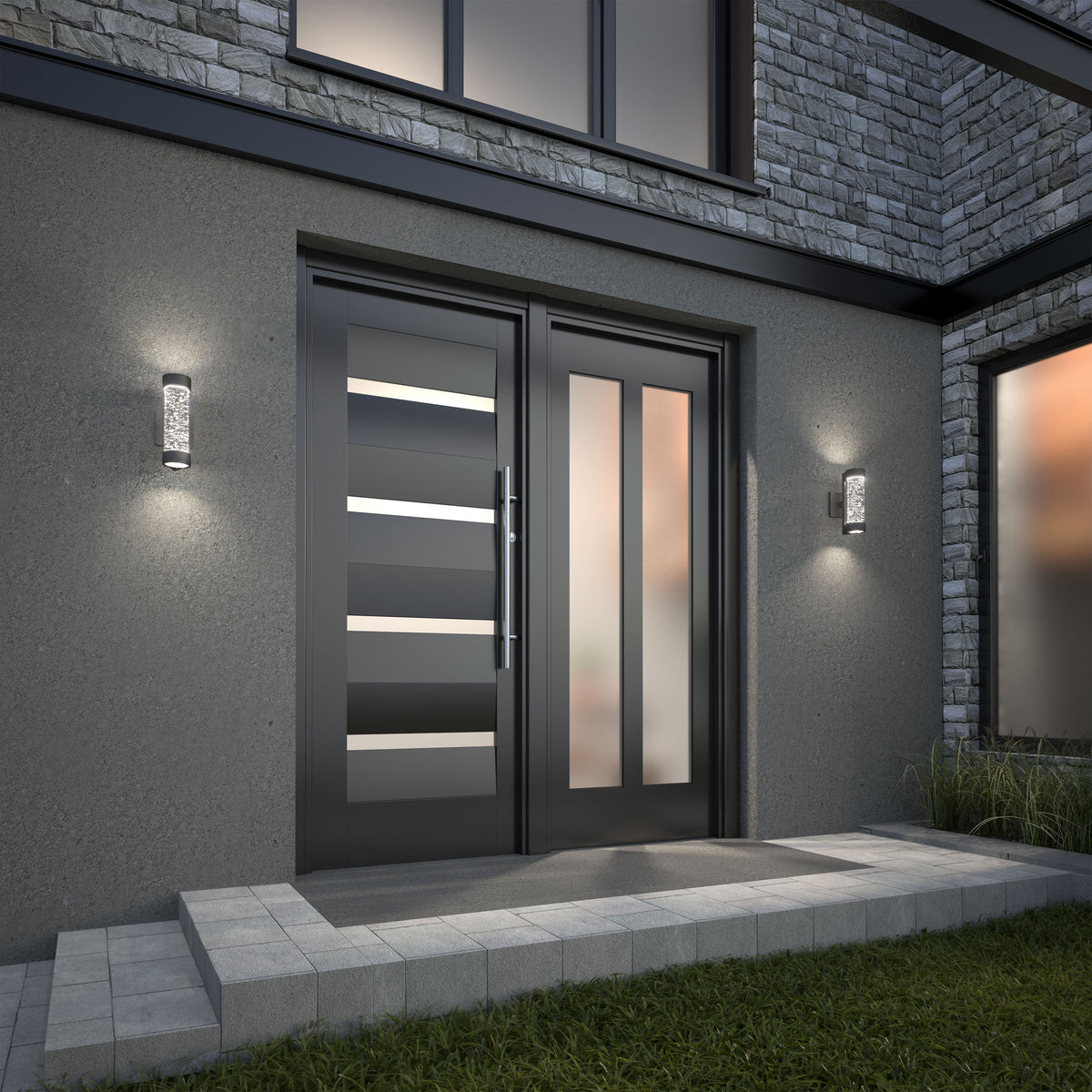 Modern front entrance with a sleek black double door featuring horizontal glass panels, flanked by two wall-mounted lights. The exterior wall is gray with stone accents, and there are concrete steps leading to the door.