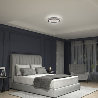 Modern bedroom with dark blue walls, gray bed, armchair, and Artika Glitter LED flush mount ceiling light.
