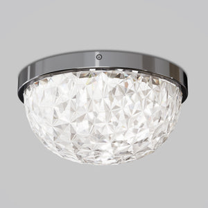 The Artika Carat LED flush mount light features a faceted, gem-like glass shade and a shiny metallic rim, installed on a plain gray ceiling.