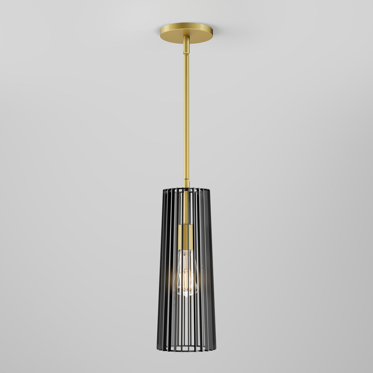 The Artika Gatsby Mini modern mid-century pendant light features a gold rod and canopy with a black vertical slat cage around the bulb, set against a plain light gray background.