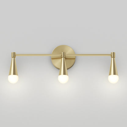 The Artika Wayden LED mid-century bathroom vanity light 3 CCT features three brass cone-shaped arms with round white bulbs, mounted on a circular backplate and displayed against a plain light gray wall.