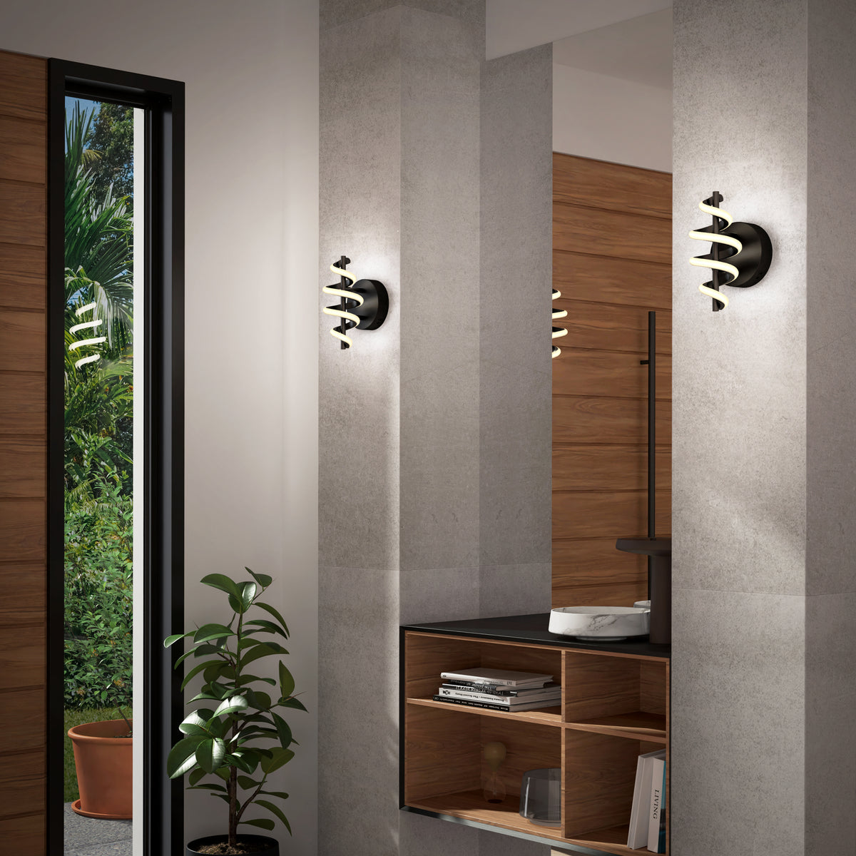 A modern interior with gray walls, two sculptural black and gold wall sconces, a wooden shelving unit with books and decor, a round white sink, and a potted plant near a tall window with a view of greenery.