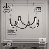 Modern black chandelier with integrated LED lights hangs in a white room with decorative molding. Text highlights features: adjustable height, matte black finish, energy efficient (no bulbs needed), and 5-year warranty.