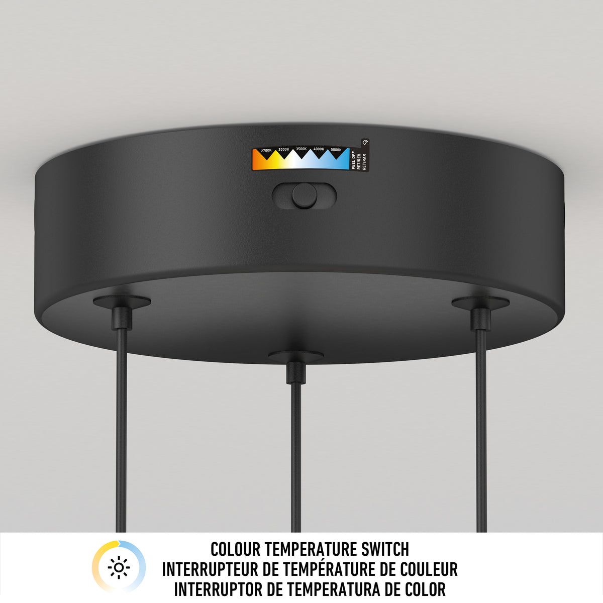 A black circular ceiling light fixture with a color temperature switch and a labeled indicator showing different light warmth settings. Three cords extend downward. A bilingual label reads “Colour Temperature Switch” in English and French.