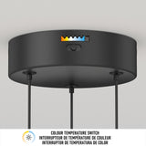 A black circular ceiling light fixture with a color temperature switch and a labeled indicator showing different light warmth settings. Three cords extend downward. A bilingual label reads “Colour Temperature Switch” in English and French.