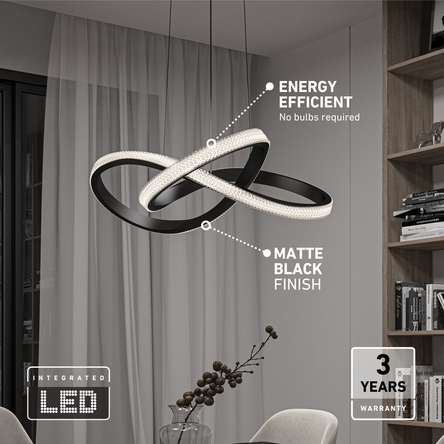 The Artika Morgan LED contemporary pendant light features matte black intertwined rings in a modern living room. Enjoy energy efficiency (no bulbs needed) and a 3-year warranty. Shelves and a window appear in the background.