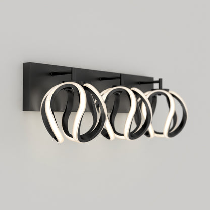 The Artika Vivaldi LED contemporary bathroom vanity light features three twisted black frames with integrated white LEDs, creating a modern look against a light gray background.