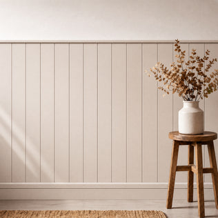 A ceramic vase with dried branches rests on a wooden stool by Artika AXEN Shilap 48 in. wall panels and a woven rug.