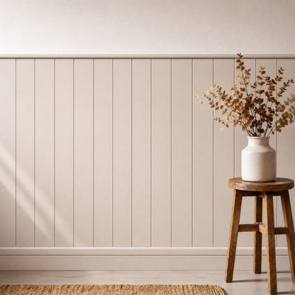 A ceramic vase with dried branches rests on a wooden stool by Artika AXEN Shilap 48 in. wall panels and a woven rug.