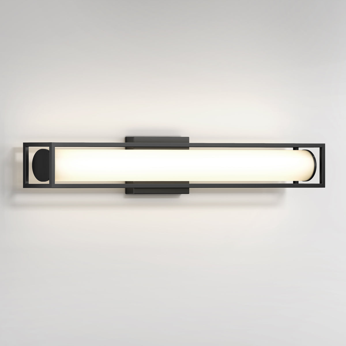 A modern wall-mounted light fixture with a rectangular black metal frame and a central cylindrical frosted glass shade emitting soft, even light.