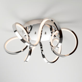 The Artika Swirl Ribbon LED flush mount light features intertwined chrome loops with integrated LED strips on a round base, offering stylish illumination and a modern touch to any contemporary space.