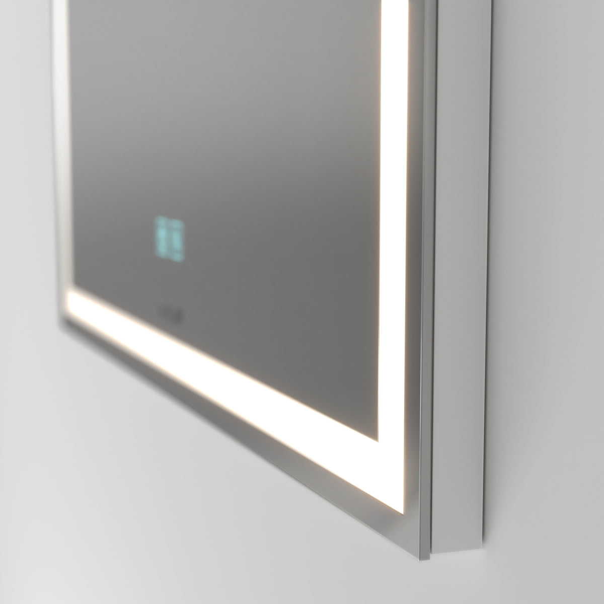 A close-up of a modern rectangular mirror mounted on a wall, featuring built-in LED lighting along its edge and a small digital display in the lower corner.