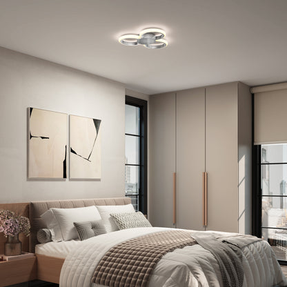 Modern bedroom with a large bed, neutral bedding, abstract art, wooden nightstand with flowers, large windows, built-in wardrobes, and an Artika Nyala 15 in. LED flush mount light 5CCT on the ceiling.