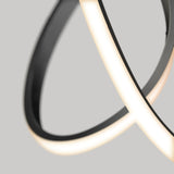 Close-up of a modern, abstract LED light fixture with curved, overlapping black and white luminous bands against a plain grey background.