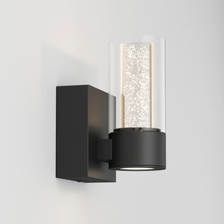 The Artika Essence 1-light LED vanity light features a black base and glass shade, ideal for dimmable accent lighting and ambiance.
