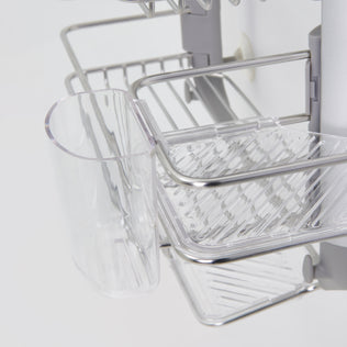 Close-up of the Artika O2 hanging Shower Caddy, featuring metal and plastic construction with a clear holder and tray for organizing items. The caddy attaches to a vertical support for efficient storage.