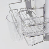 Close-up of a metal and plastic kitchen rack with a clear plastic cup and tray, designed for organizing utensils and draining water, attached to a vertical rod.