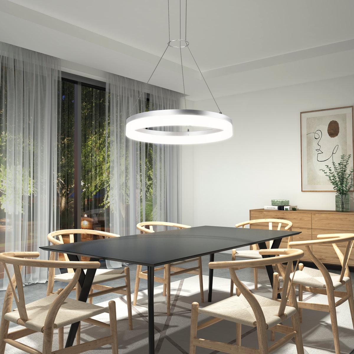 A modern dining room with a black rectangular table, six wooden chairs with curved backs, a glowing circular pendant light, sheer curtains, and minimalist wall art above a wooden sideboard with a vase and small decor items.
