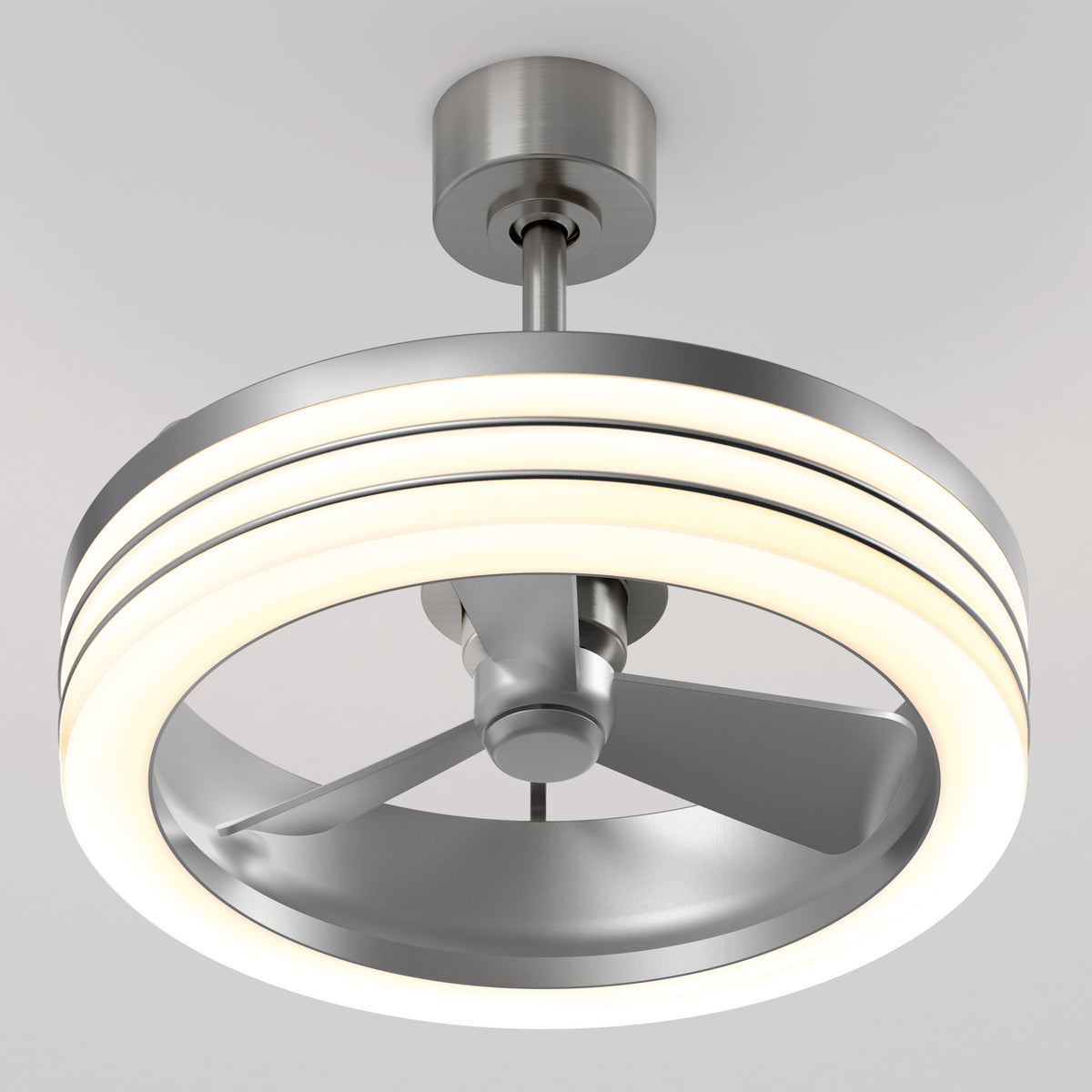 A modern ceiling fan with three metal blades enclosed in a circular LED light fixture, mounted on a white ceiling. The design is sleek and contemporary, combining lighting and airflow in one unit.