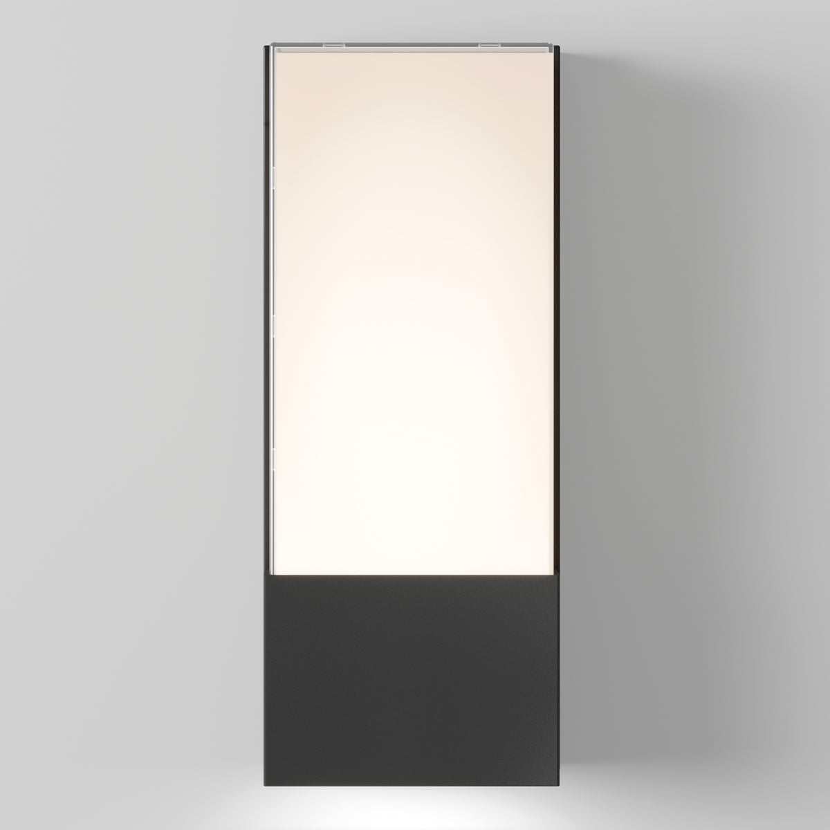 A tall, rectangular lightbox with a black base and a softly glowing illuminated panel above, standing against a plain light gray background.