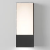 A tall, rectangular lightbox with a black base and a softly glowing illuminated panel above, standing against a plain light gray background.