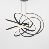 A modern ceiling light fixture featuring several intertwined black and white LED rings, suspended by thin cables against a plain white background.