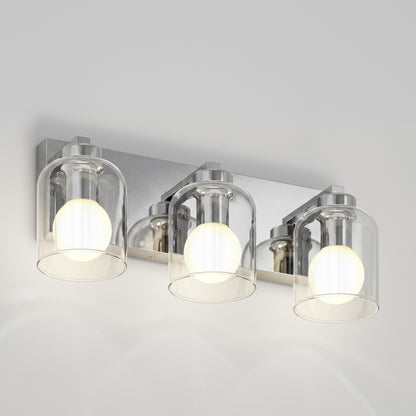 Artika Aryna 20 in. (51 cm) 3-Light LED Wall Vanity 3000K with three glass bell shades and glowing bulbs on a rectangular chrome base.