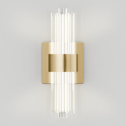 The Artika Dorado LED Contemporary Wall Sconce features a brushed brass rectangular base and vertical clear glass rods, evenly spaced to emit soft light, enhancing any neutral wall with modern elegance.