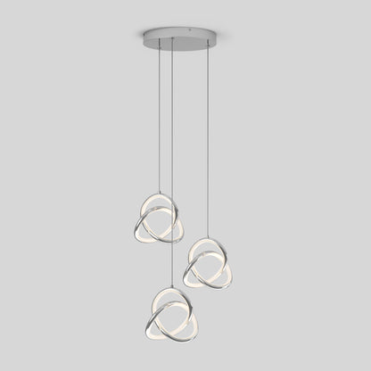 The Artika Zephyr 3-light LED pendant features intertwined metallic rings with integrated LEDs, suspended from a round ceiling mount by thin cords, set against a plain light gray background.