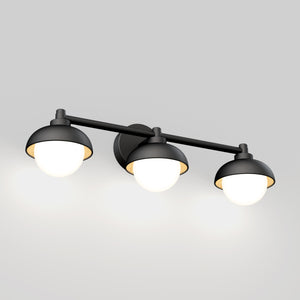 The Artika Boden 27-in (69 cm) Integrated LED 5-CCT Vanity Light Bar features three black and white round lampshades on a horizontal rod, each offering adjustable color temperature for a warm glow—ideal for modern bathrooms.